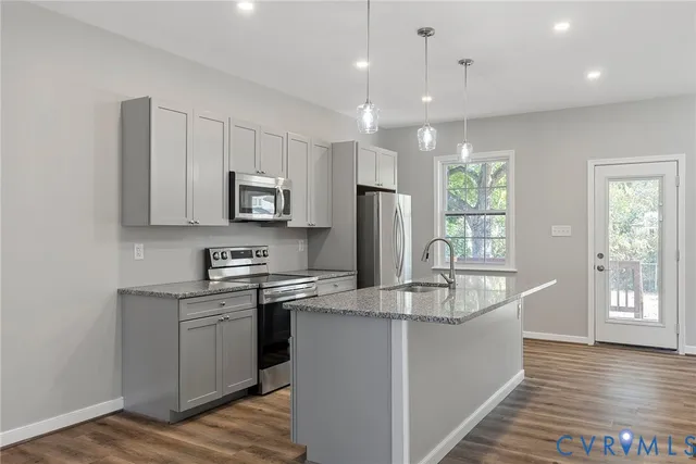 a kitchen with counter top space cabinets and appliances
