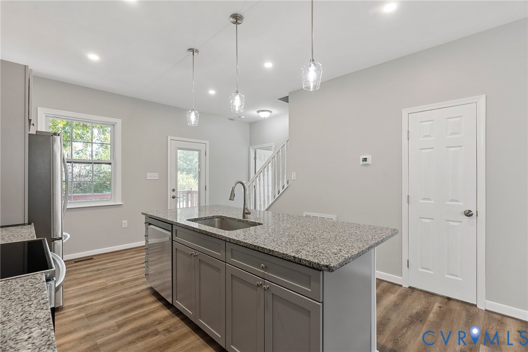 2768 Venter Road Aylett, VA 23009 - Photo 8 of 31 a kitchen with a sink granite counter tops and a wooden floor
