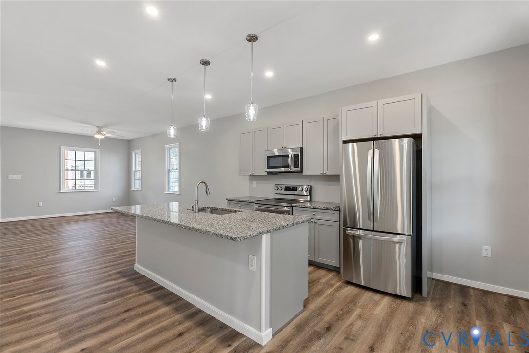 2768 Venter Road Aylett, VA 23009 - Photo 9 of 31 a kitchen with stainless steel appliances granite countertop a refrigerator a sink dishwasher a stove and white countertops with wooden floor