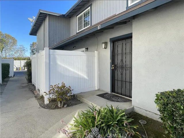 a view of a front door and potted plants