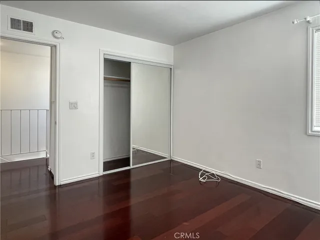 an empty room with wooden floor