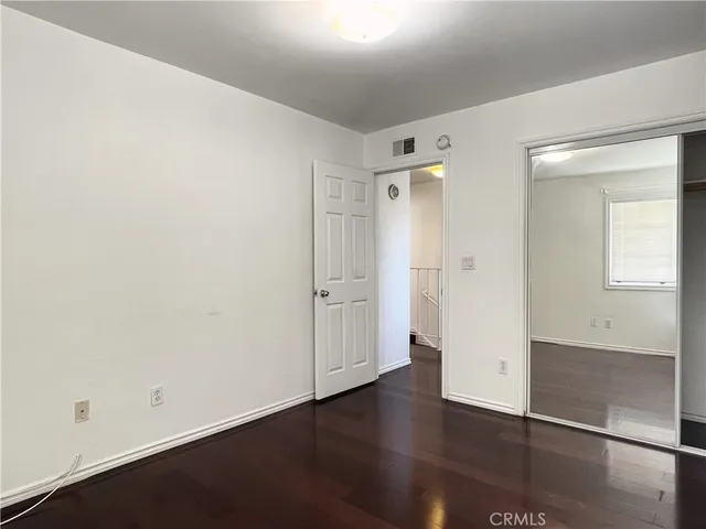 an empty room with wooden floor