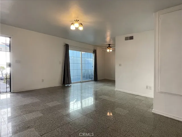 an empty room with windows and entrance