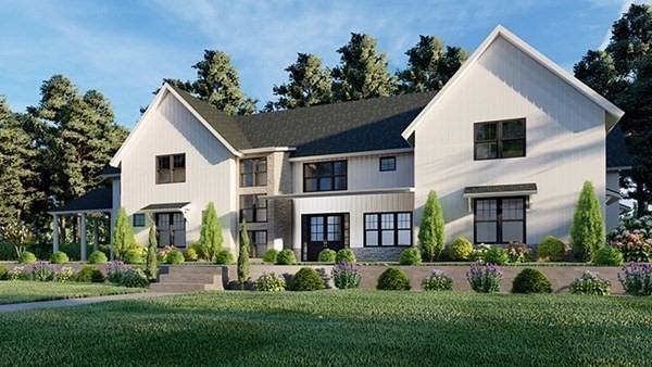 a front view of a house with a yard and potted plants