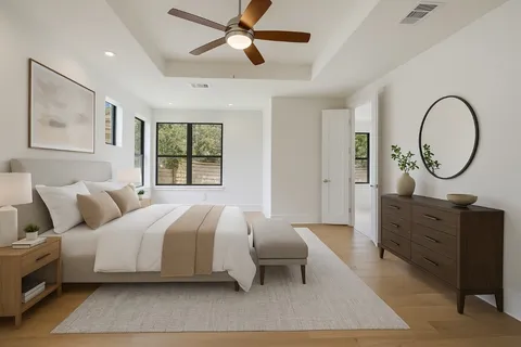 a bedroom with a large bed and a chandelier