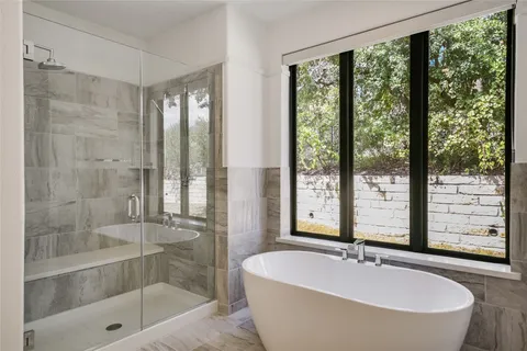 a spacious bathroom with shower bathtub and sink