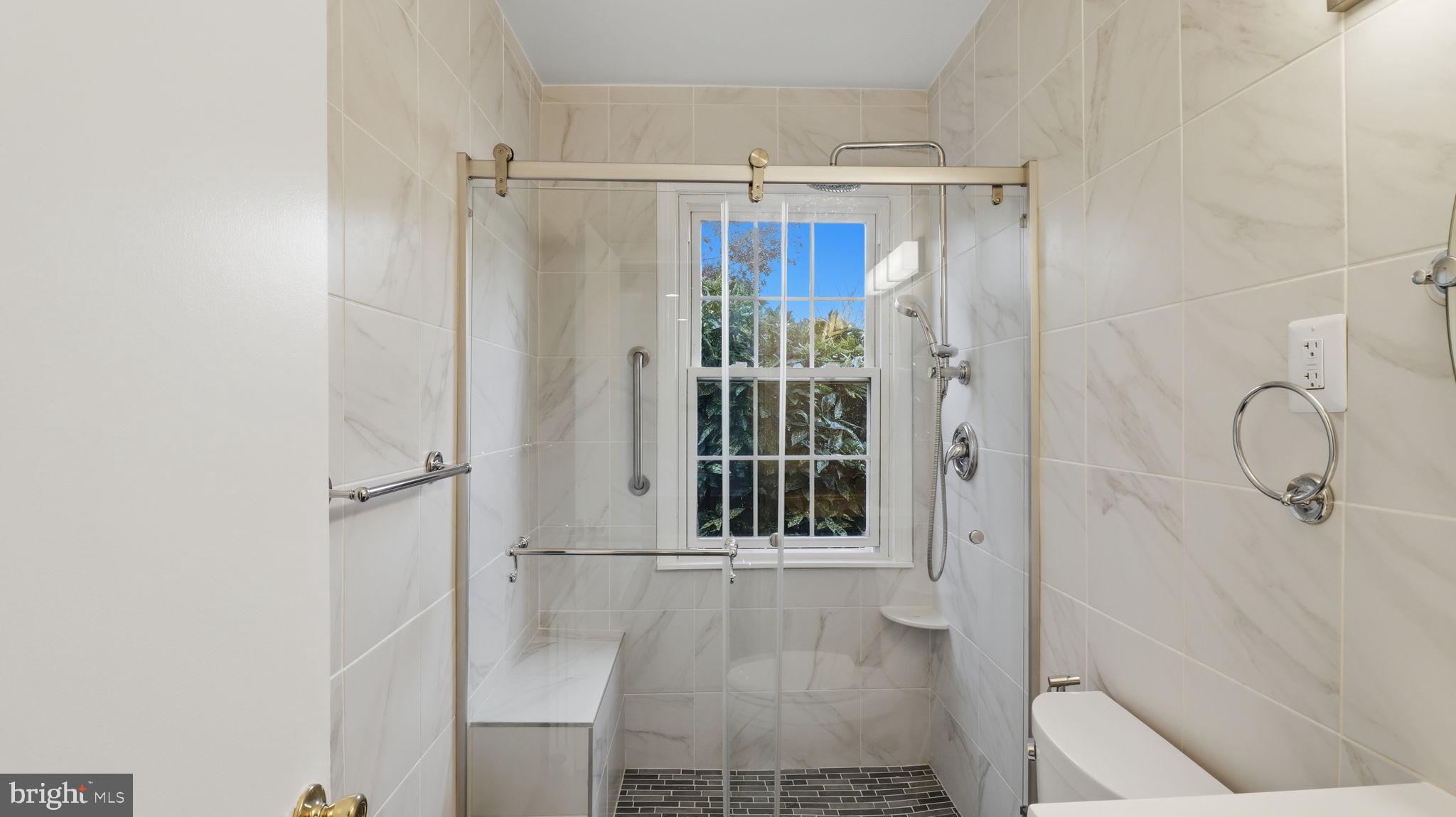 5100 Columbia Pike, Unit 1 Arlington, VA 22204 - Photo 18 of 40 a bathroom with a glass shower door