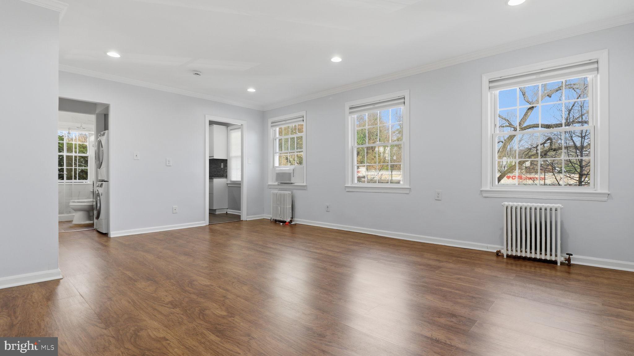 5100 Columbia Pike, Unit 1 Arlington, VA 22204 - Photo 20 of 40 a view of an empty room with wooden floor and a window