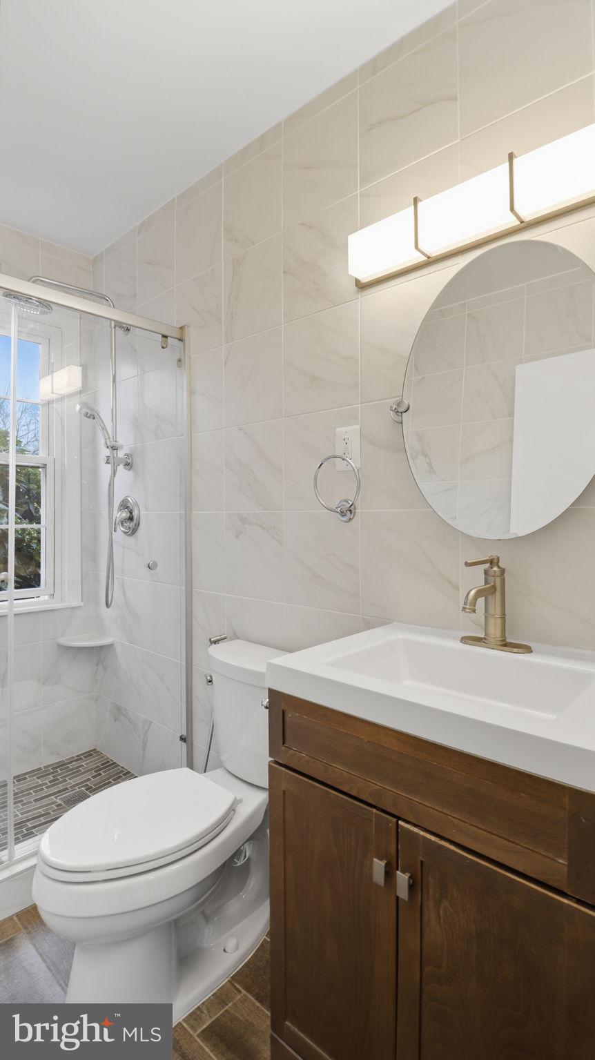 5100 Columbia Pike, Unit 1 Arlington, VA 22204 - Photo 21 of 40 a bathroom with a sink a toilet and a mirror