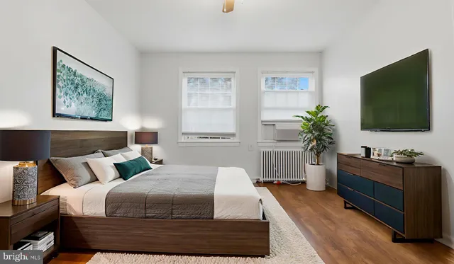 a bedroom with a bed and a flat screen television