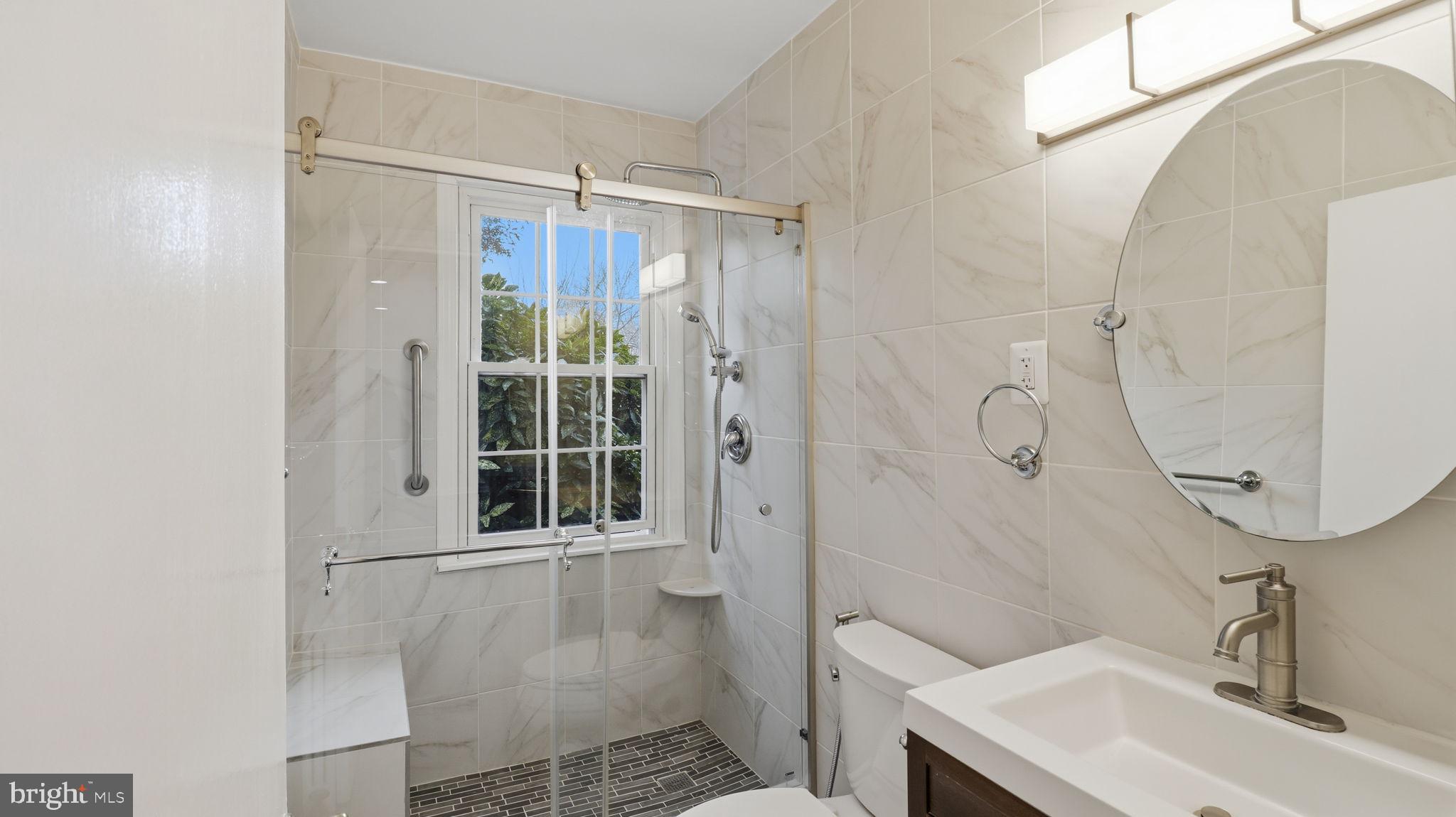 5100 Columbia Pike, Unit 1 Arlington, VA 22204 - Photo 27 of 40 a bathroom with a sink a toilet and shower