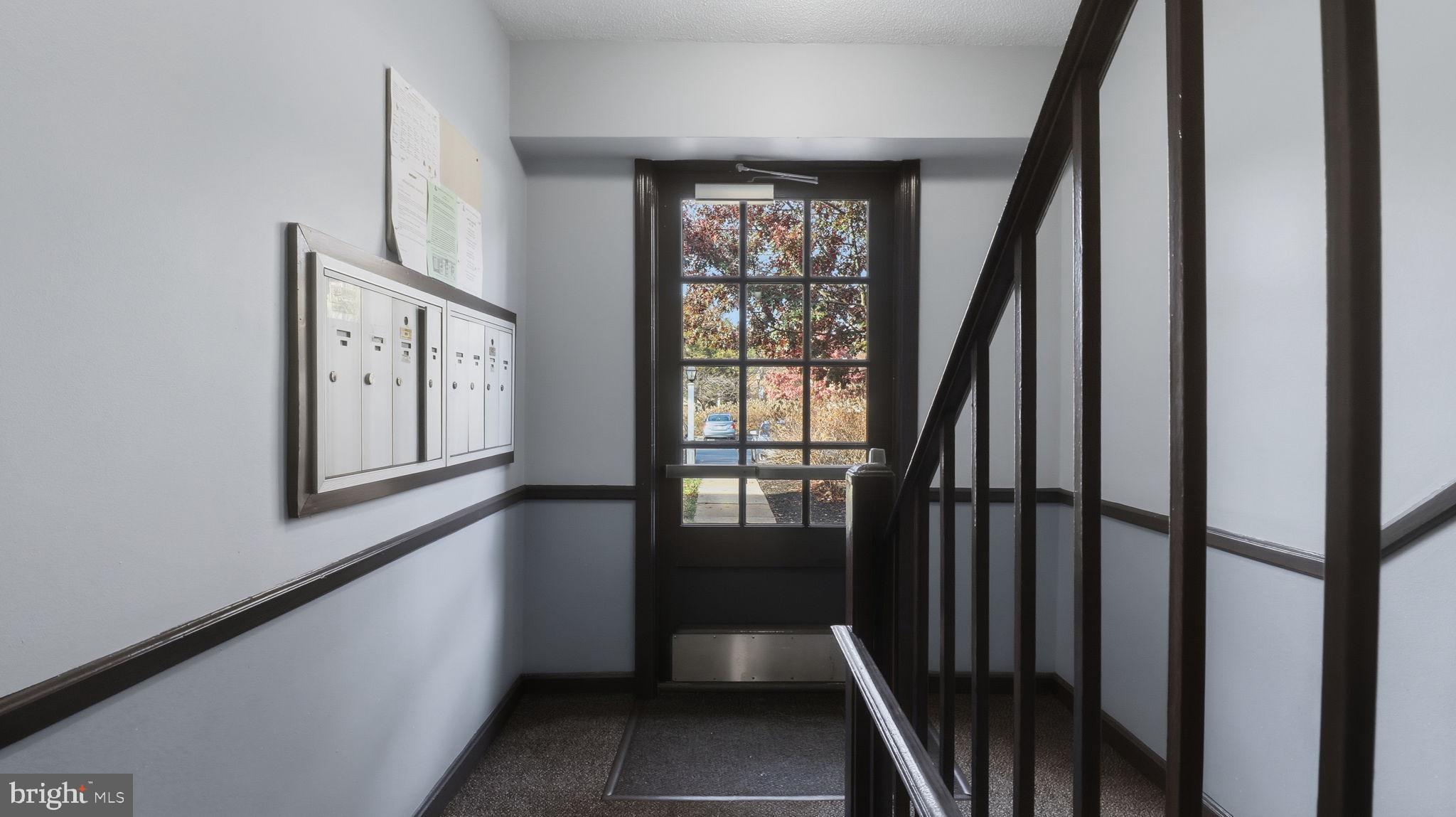 5100 Columbia Pike, Unit 1 Arlington, VA 22204 - Photo 3 of 40 a view of a hallway with wooden floor and stairs