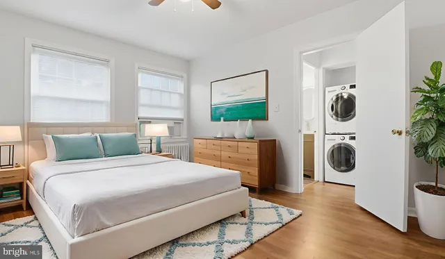 a bedroom with a bed a mirror and dresser