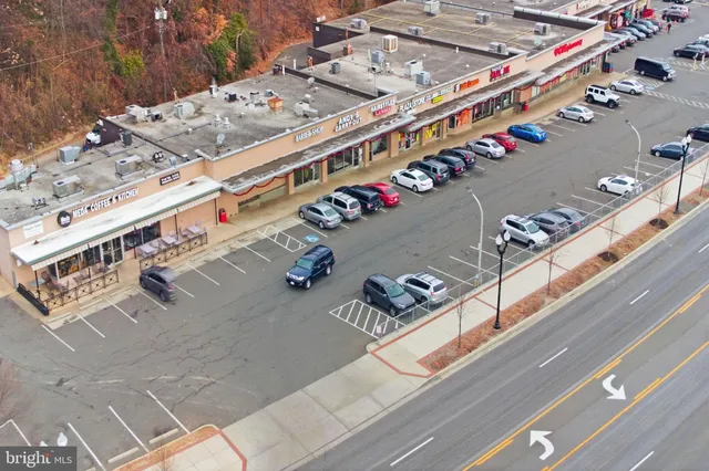 a car parked in front of a brick house next to a yard