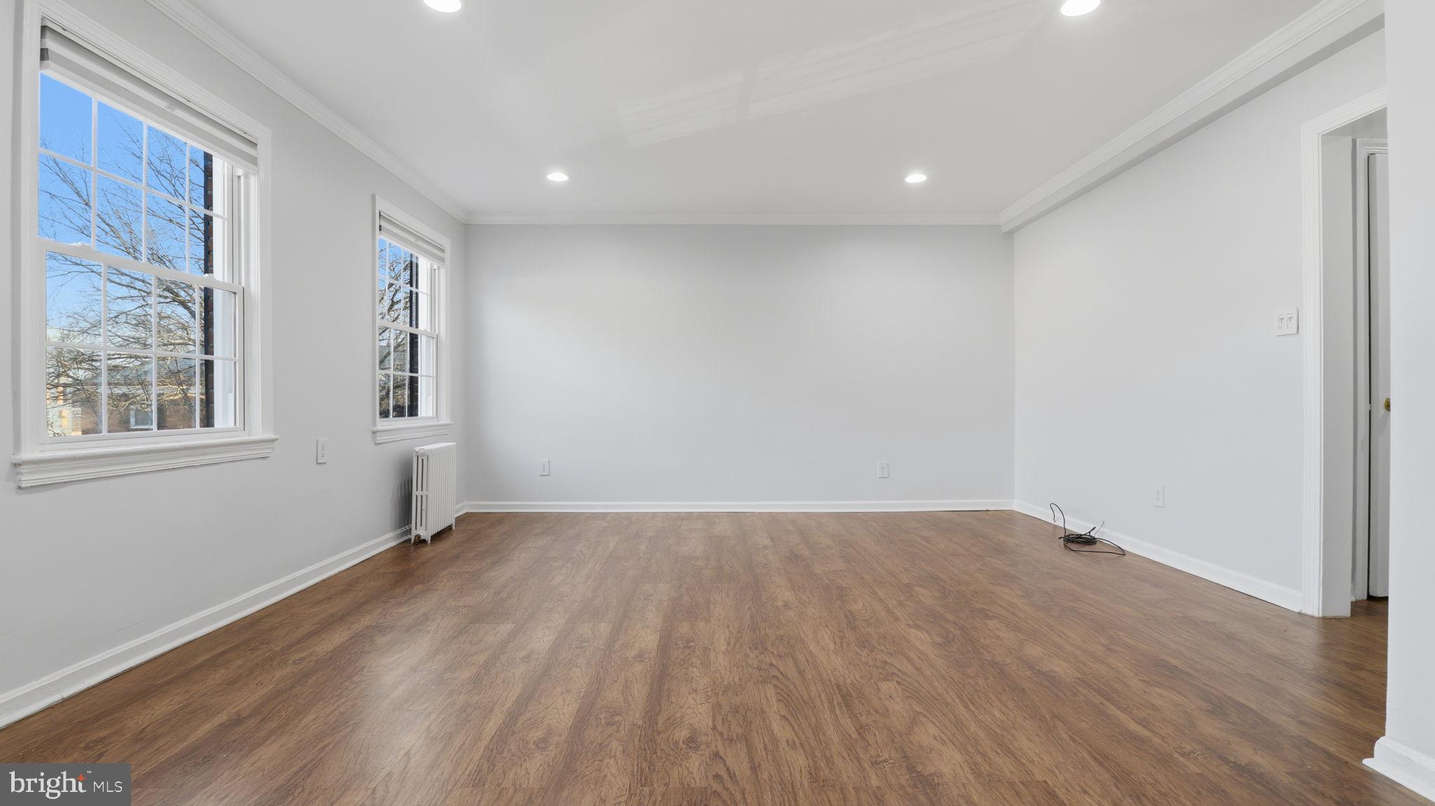 5100 Columbia Pike, Unit 1 Arlington, VA 22204 - Photo 7 of 40 a view of an empty room with wooden floor and a window