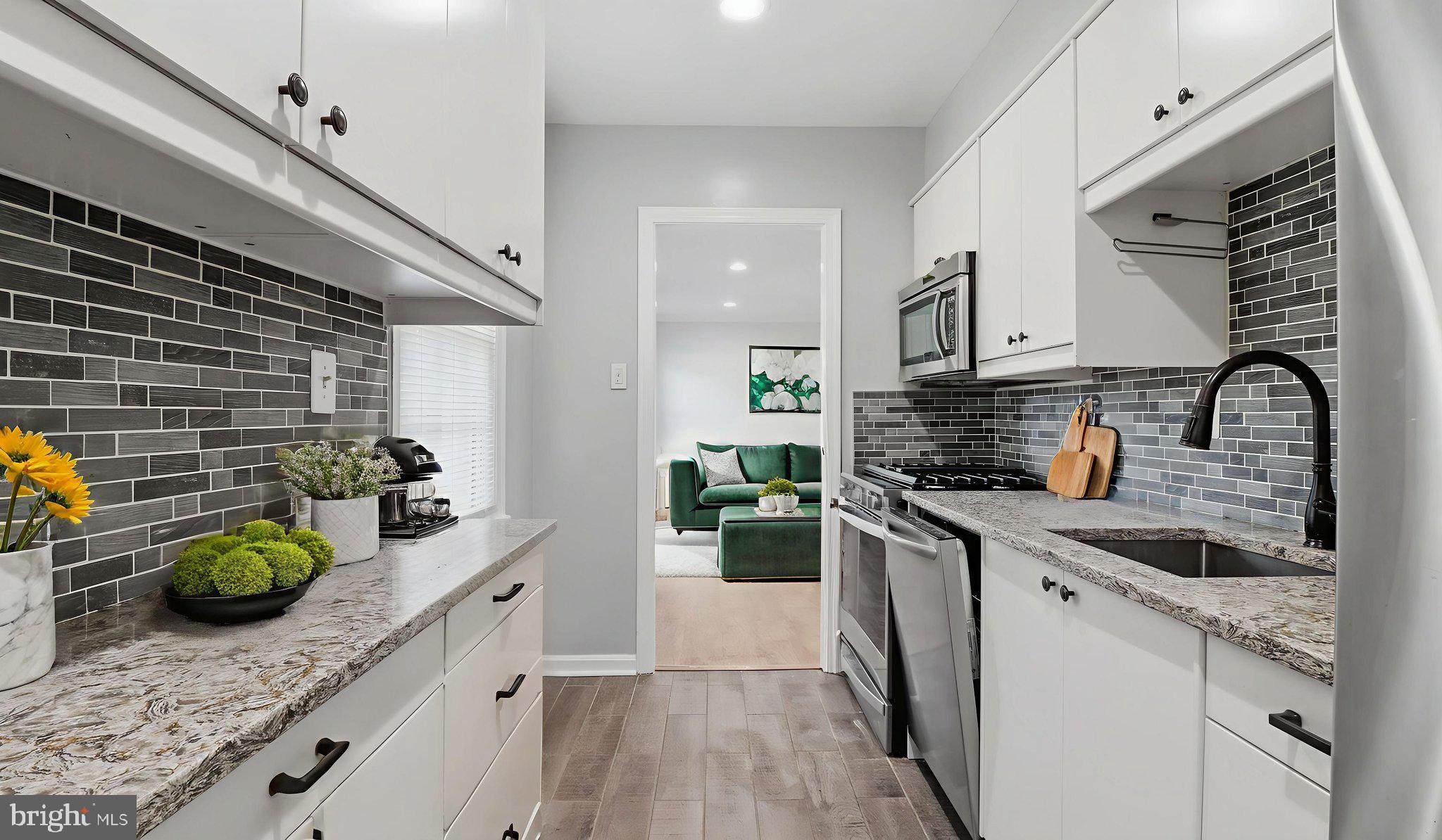 5100 Columbia Pike, Unit 1 Arlington, VA 22204 - Photo 9 of 40 a kitchen with stainless steel appliances granite countertop a sink a stove and cabinets
