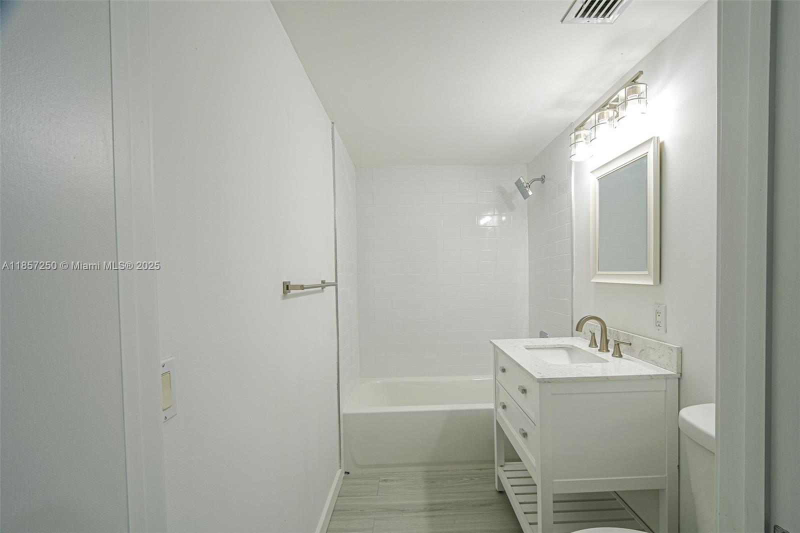 2740 Southwest 28th Terrace, Unit 603 Miami, FL 33133 - Photo 11 of 21 a bathroom with a sink a toilet and shower