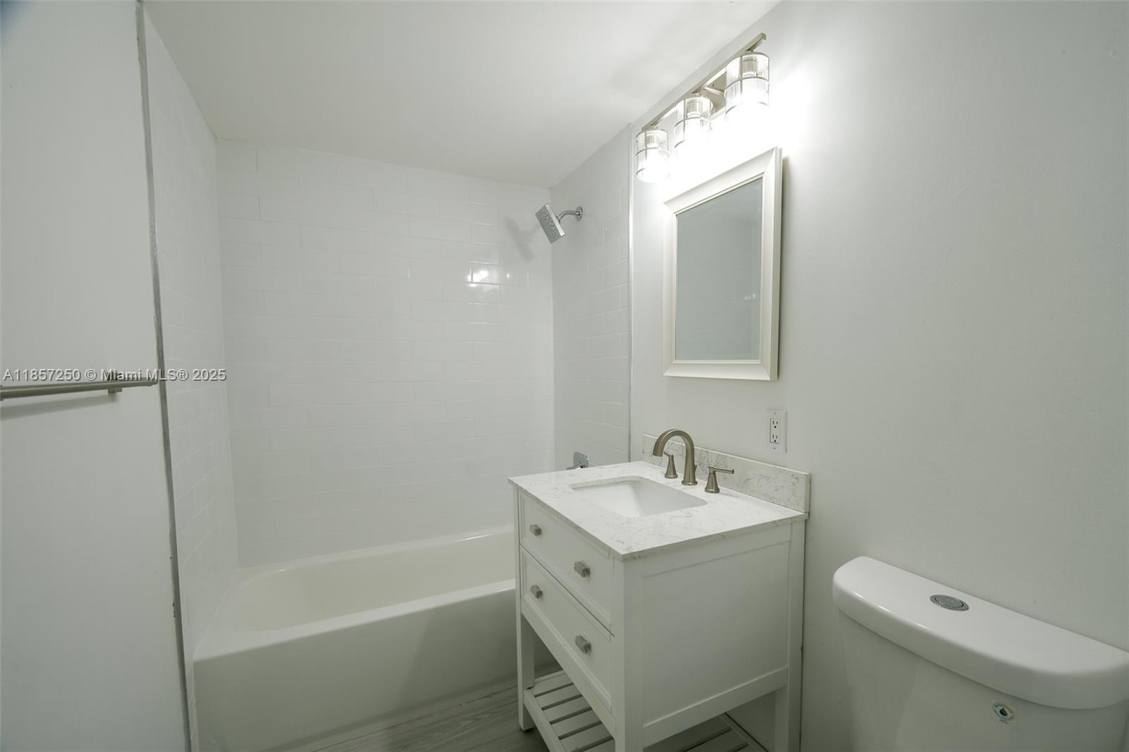2740 Southwest 28th Terrace, Unit 603 Miami, FL 33133 - Photo 12 of 21 a bathroom with a sink a toilet and shower