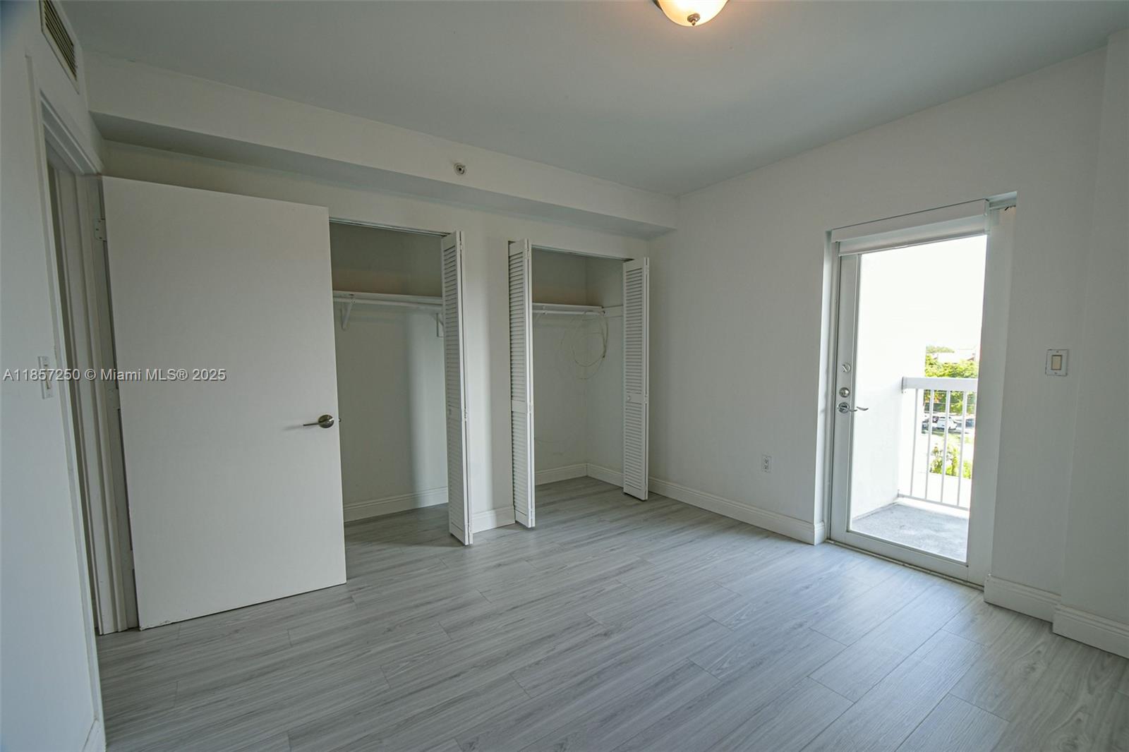 2740 Southwest 28th Terrace, Unit 603 Miami, FL 33133 - Photo 14 of 21 an empty room with wooden floor and windows