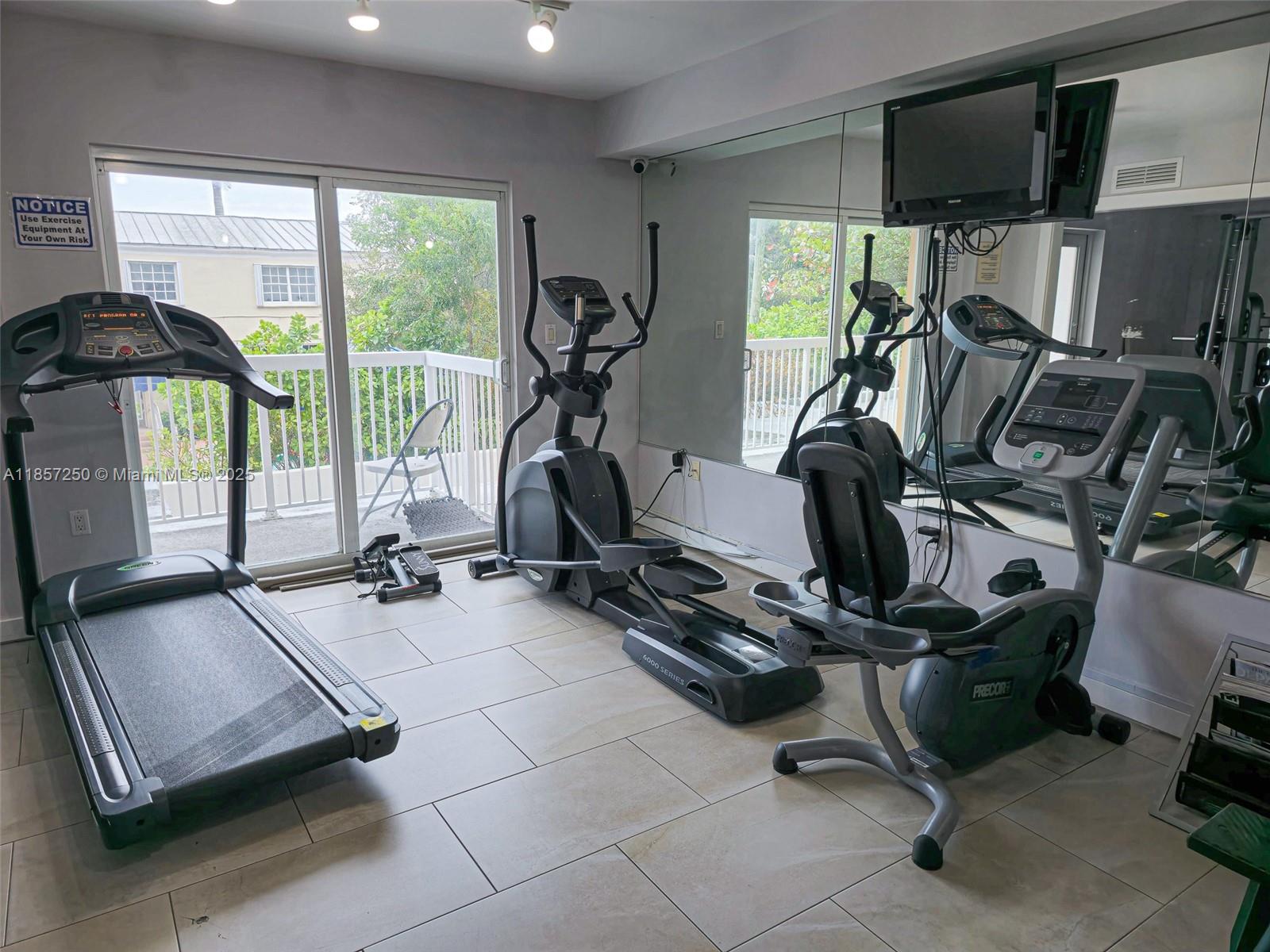 2740 Southwest 28th Terrace, Unit 603 Miami, FL 33133 - Photo 18 of 21 a room with gym equipment and windows