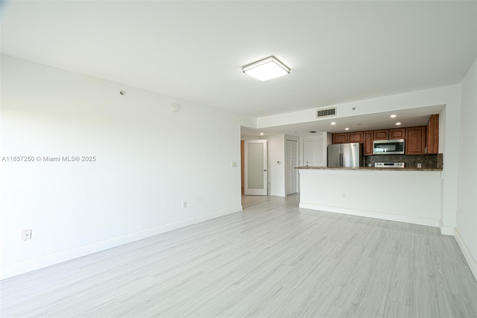 2740 Southwest 28th Terrace, Unit 603 Miami, FL 33133 - Photo 6 of 21 a view of a kitchen with wooden floor and a kitchen