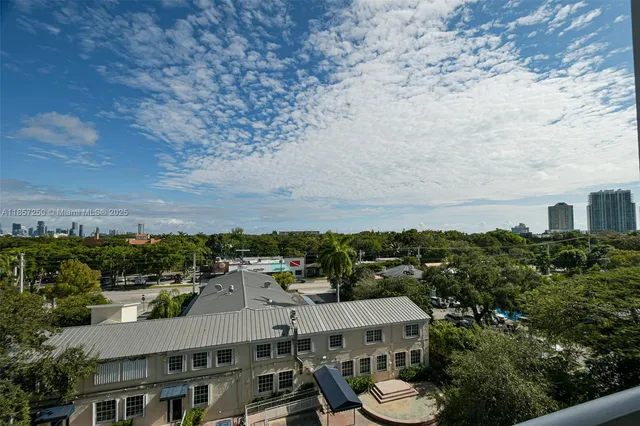 a view of an empty room with closet and a window