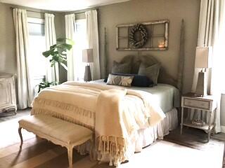 248 Blueberry Road Freeport, FL 32439 - Photo 13 of 37 a bedroom with a bed and a chandelier