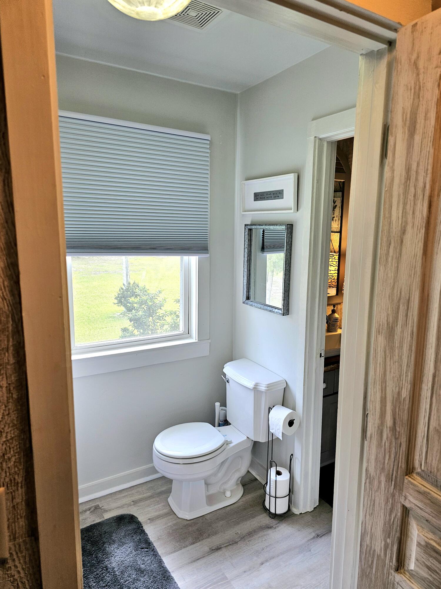 248 Blueberry Road Freeport, FL 32439 - Photo 29 of 37 a bathroom with a toilet and a window