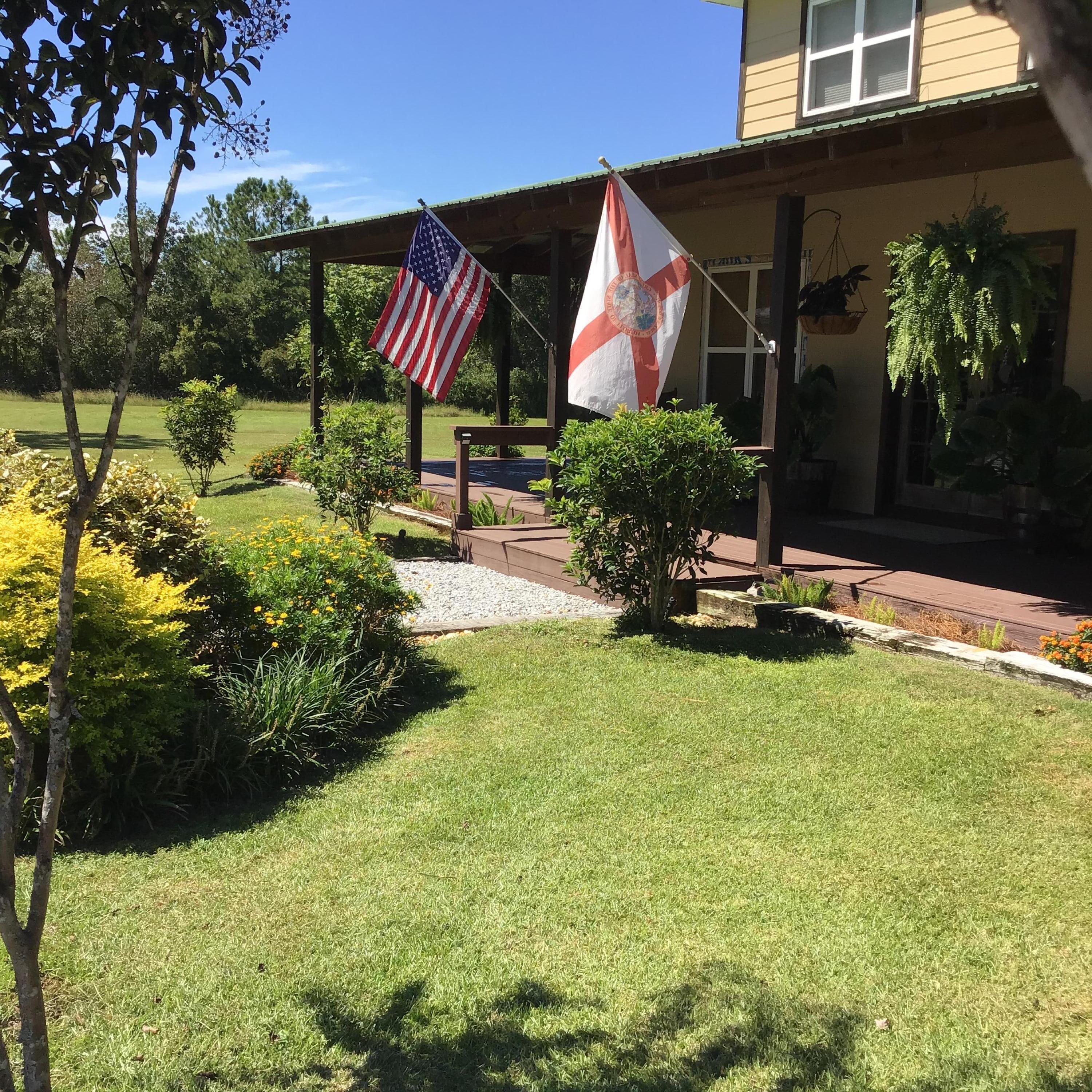 248 Blueberry Road Freeport, FL 32439 - Photo 3 of 37 a view of backyard with table and chairs and potted plants