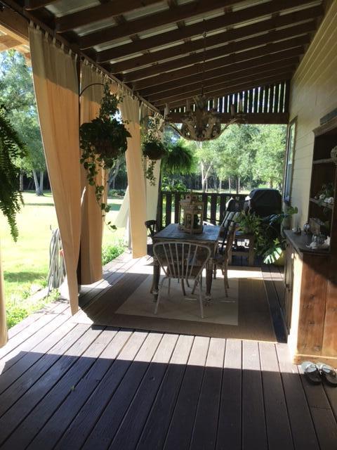 248 Blueberry Road Freeport, FL 32439 - Photo 5 of 37 a view of a porch with furniture and a yard
