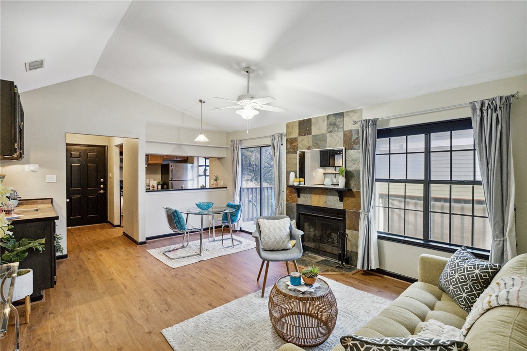 a living room with furniture fireplace and a flat screen tv