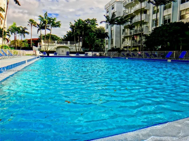 a view of yard with swimming pool and trees in the background