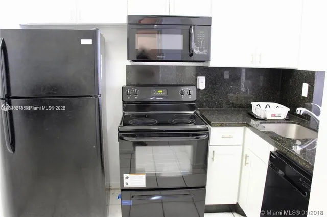 a stove top oven sitting inside of a kitchen