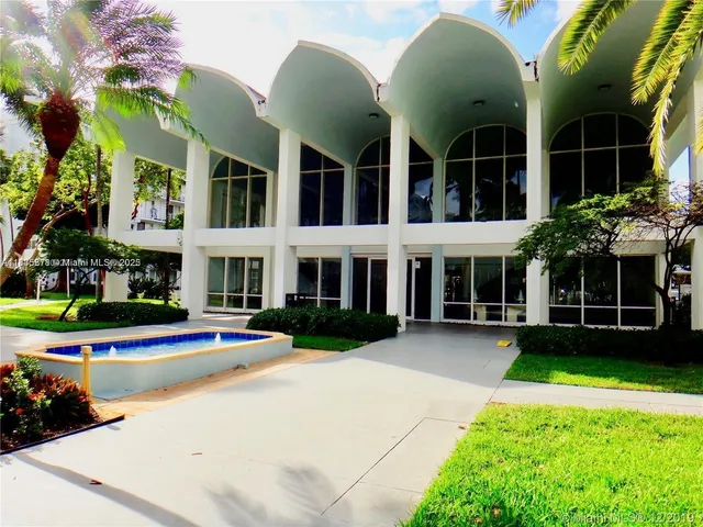 a view of an apartment with a swimming pool