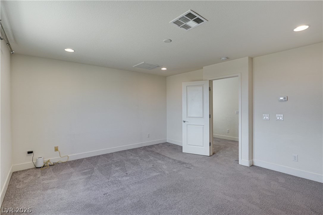 5954 Smith Valley Road Las Vegas, NV 89148 - Photo 14 of 23 A spacious, naturally illuminated room featuring plush carpeting and recessed lighting.