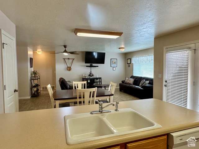 445 Topaz Boulevard, Unit 10 Delta, UT 84624 - Photo 28 of 28 Kitchen with a sink, dishwasher, a textured ceiling, ceiling fan, and open floor plan