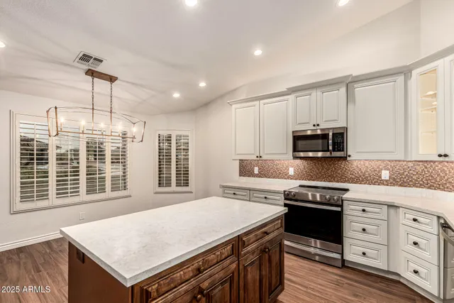 a kitchen with a sink cabinets and wooden floor