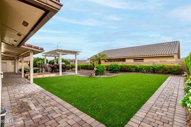 a front view of a house with a garden and yard