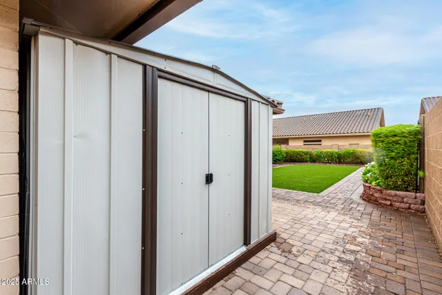 a view of a house with a patio and a garden