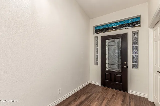 a view of a livingroom with wooden floor and a window