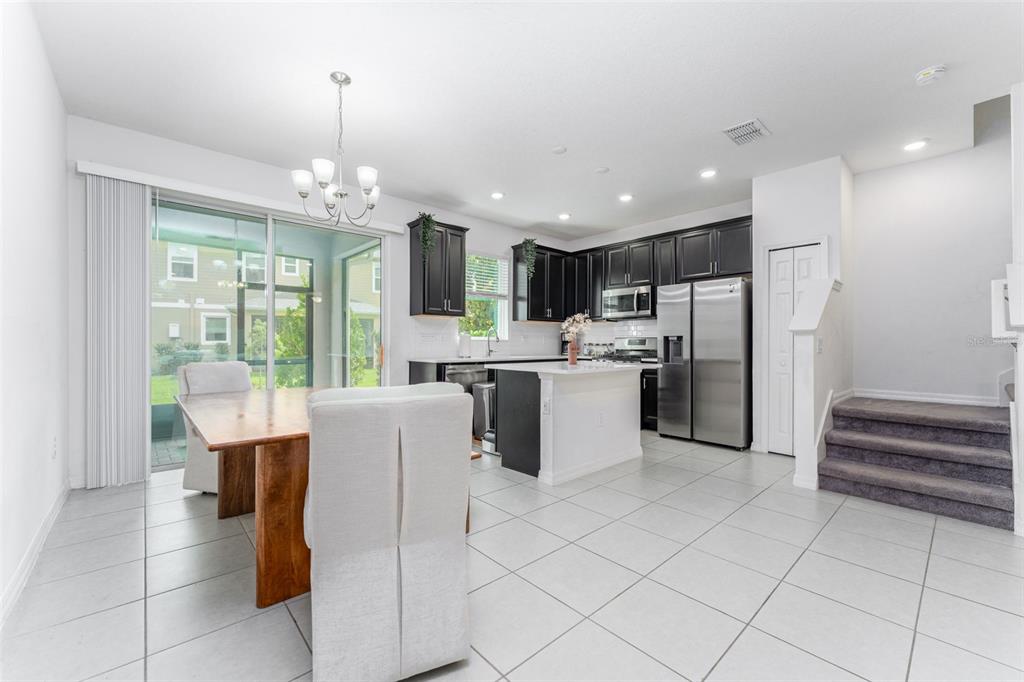 14072 Kite Lane Lithia, FL 33547 - Photo 12 of 25 a kitchen with kitchen island stainless steel appliances a stove refrigerator sink and microwave