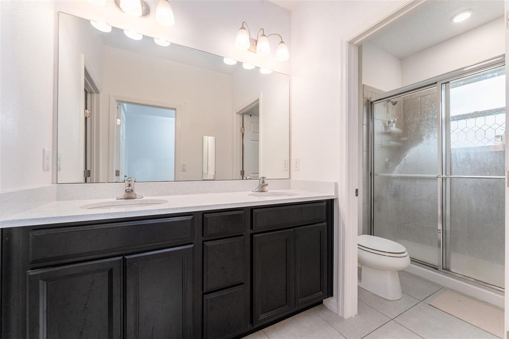 14072 Kite Lane Lithia, FL 33547 - Photo 17 of 25 a bathroom with a double vanity sink mirror and toilet