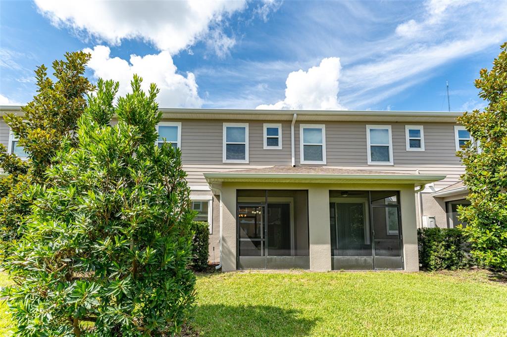 14072 Kite Lane Lithia, FL 33547 - Photo 24 of 25 a view of a brick house with a large windows and a large tree