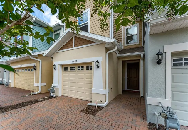 a view of a house with a yard and garage