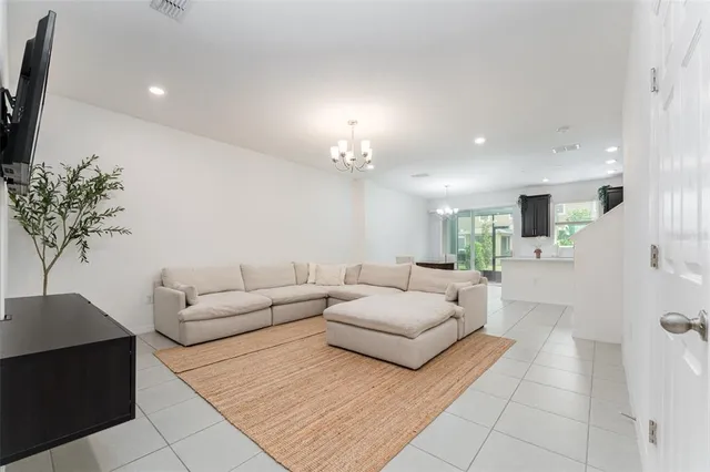 a living room with furniture and a chandelier