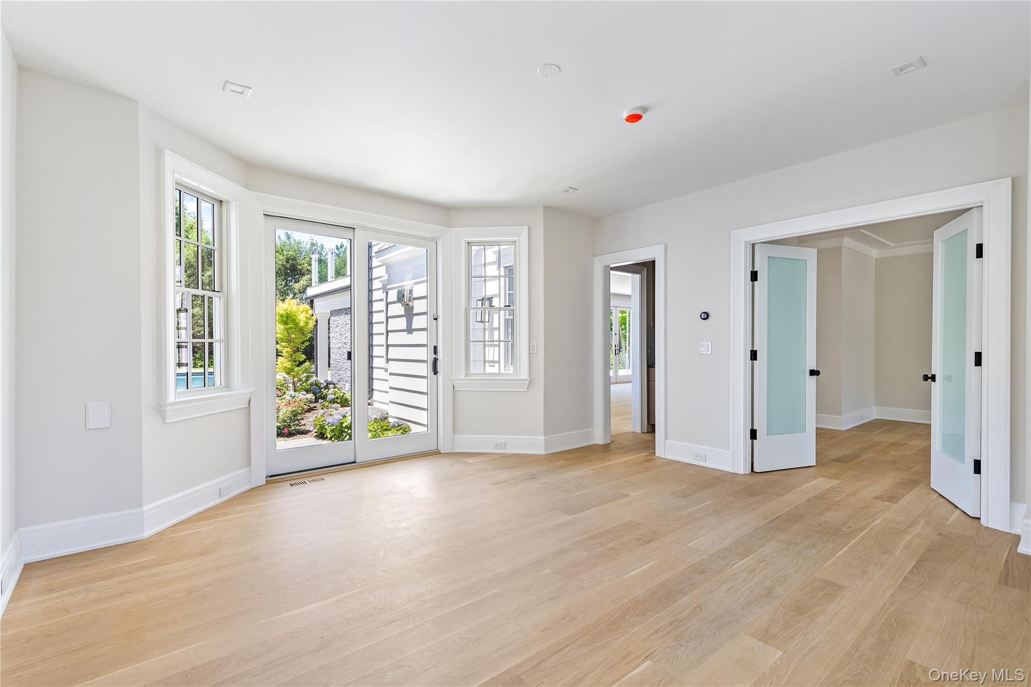 42 Mamaroneck Road Scarsdale, NY 10583 - Photo 21 of 47 The private first-floor office offers a quiet workspace with sliding doors, picturesque pool views, a convenient wet bar, and direct access to both the family room and wellness wing.