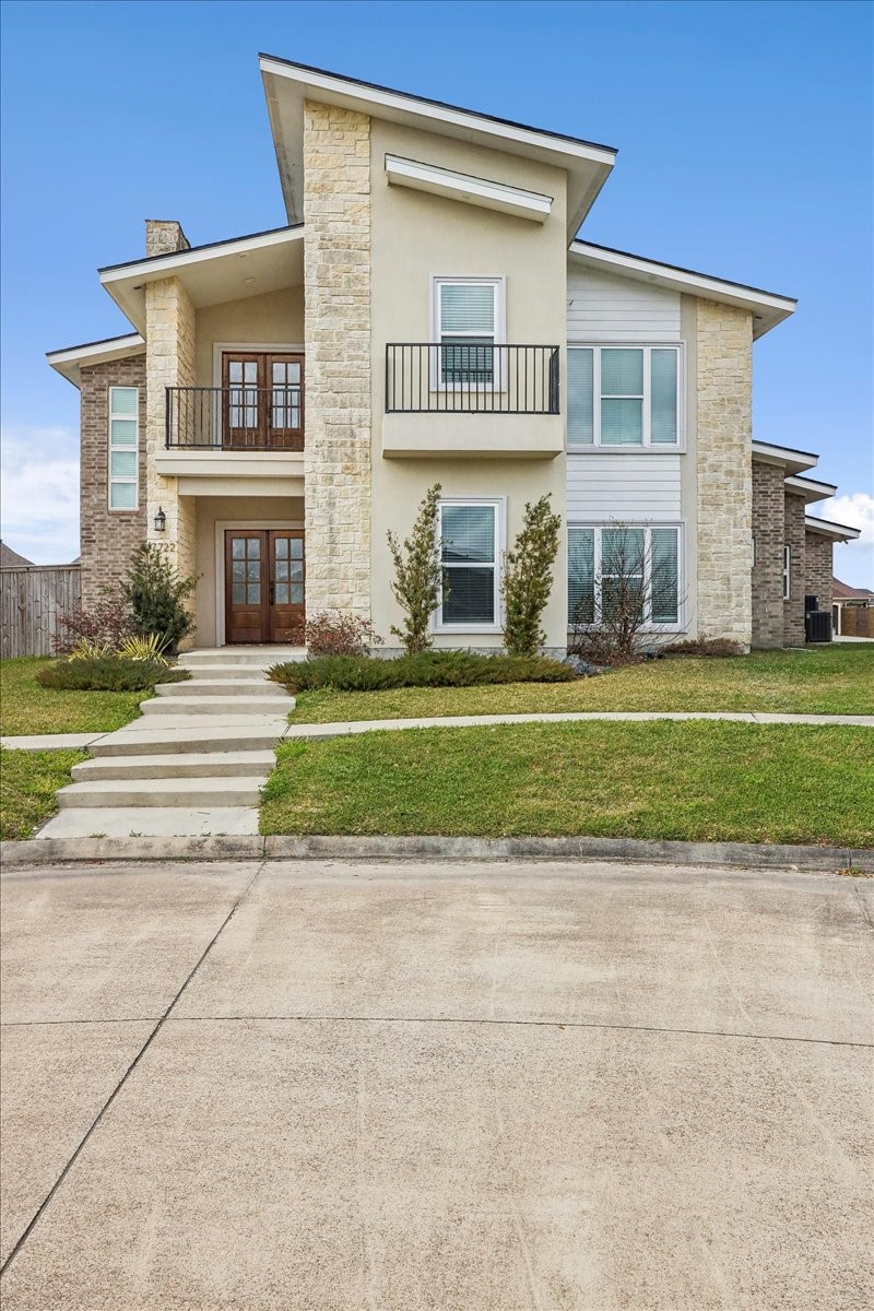 7722 Pond Circle Beaumont, TX 77707 - Photo 2 of 42 a front view of a house with a yard