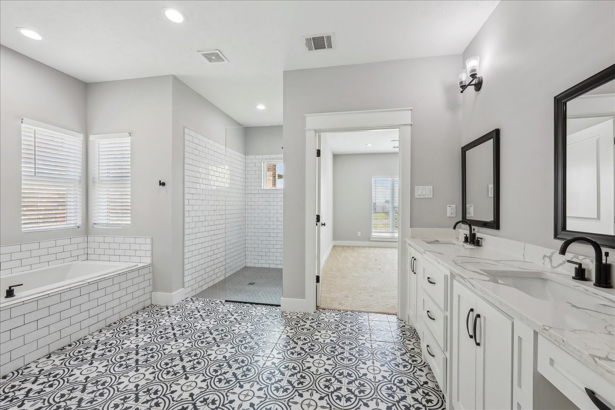 7722 Pond Circle Beaumont, TX 77707 - Photo 21 of 42 a spacious bathroom with a double vanity sink a mirror and a shower