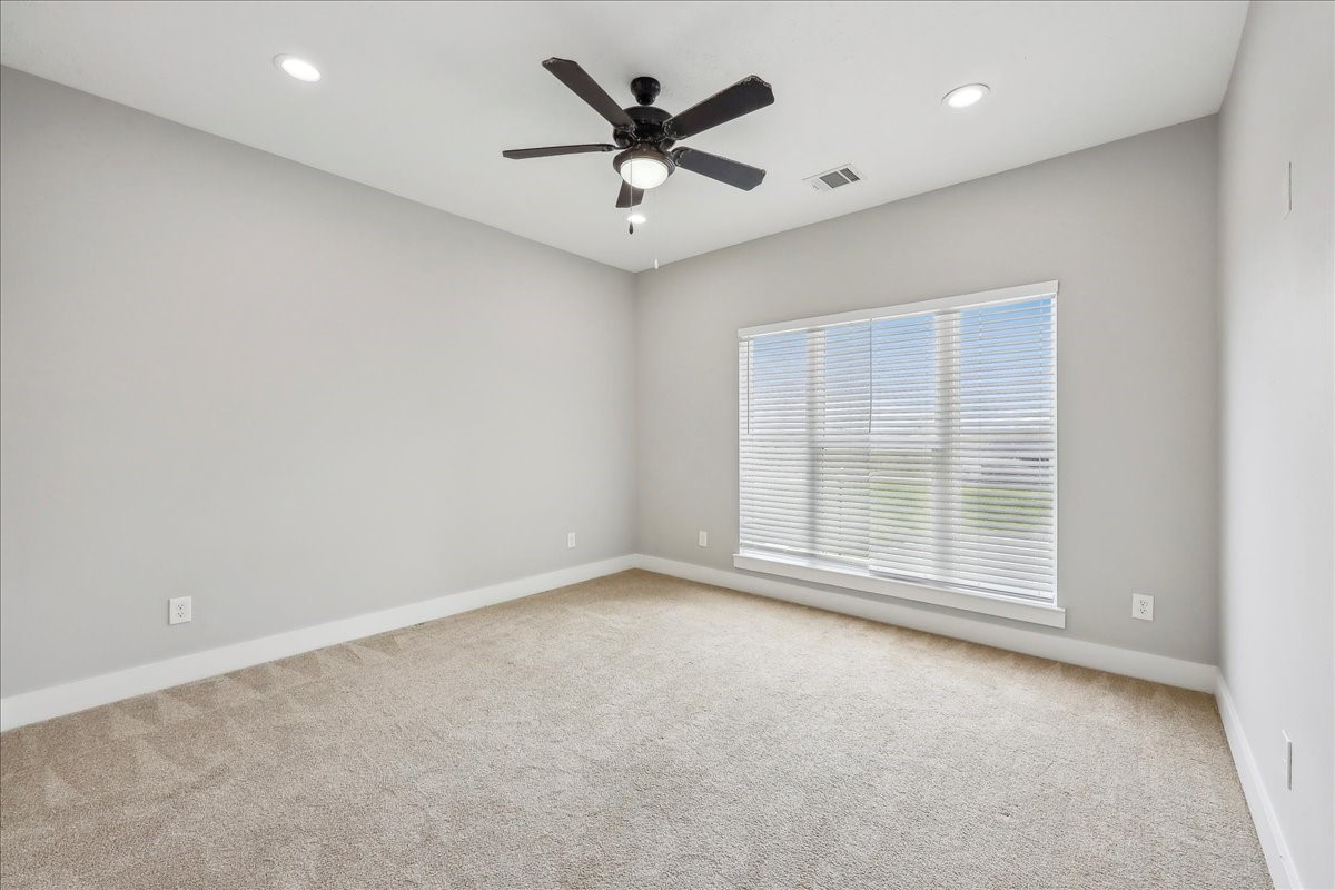 7722 Pond Circle Beaumont, TX 77707 - Photo 31 of 42 an empty room with ceiling fan and windows