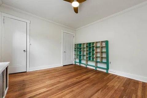 a view of an empty room and a bathroom